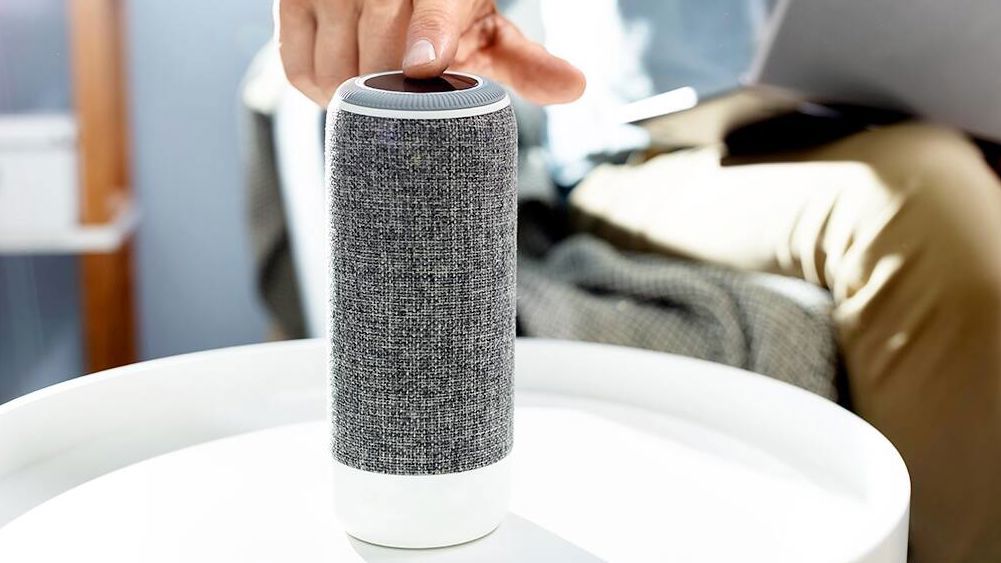 A man touching a Bose speaker